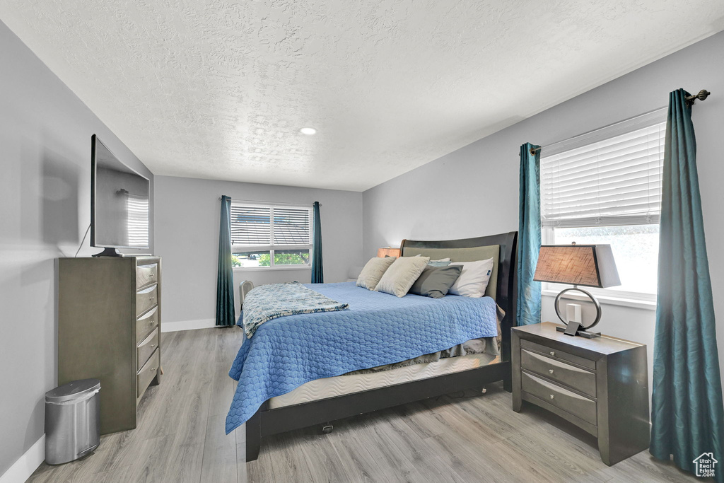 Bedroom featuring a textured ceiling and light wood-style flooring