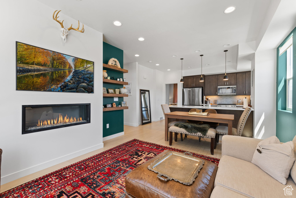 Living area featuring recessed lighting and a glass covered fireplace