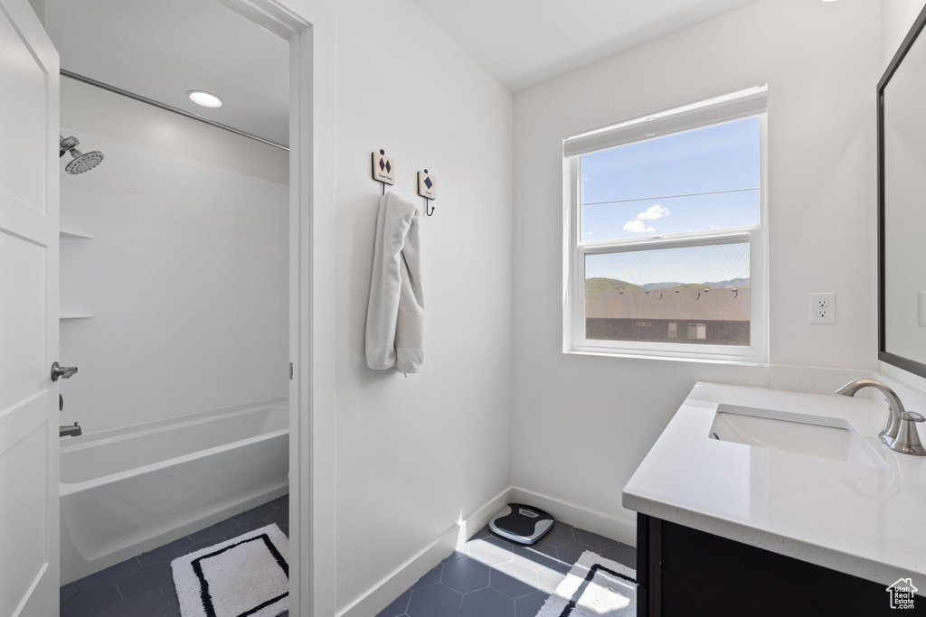 Bathroom featuring vanity, tile patterned flooring, and bathtub / shower combination