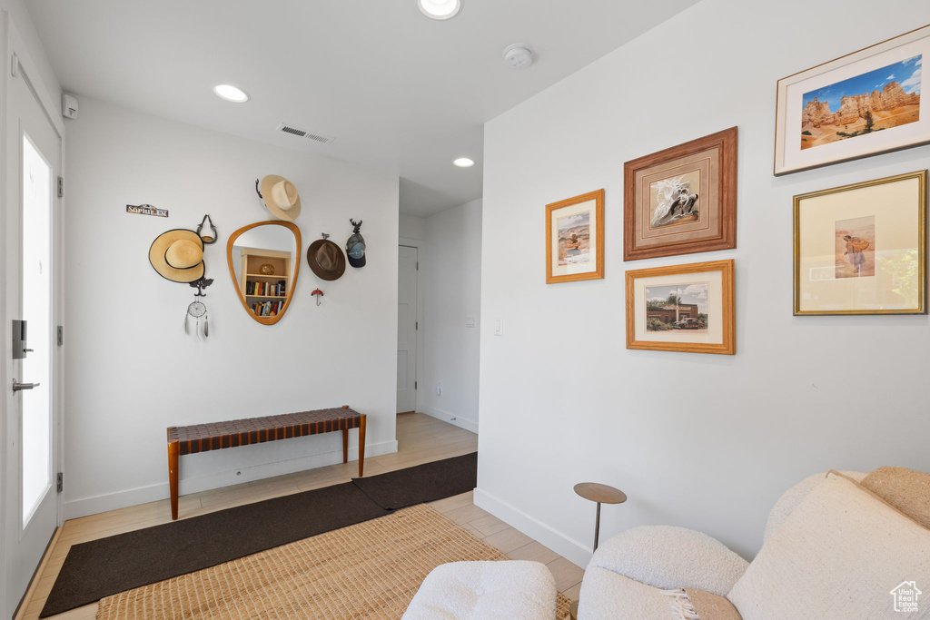 Living area with recessed lighting and baseboards