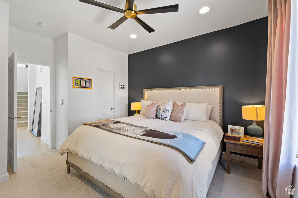 Bedroom with light colored carpet, recessed lighting, and ceiling fan