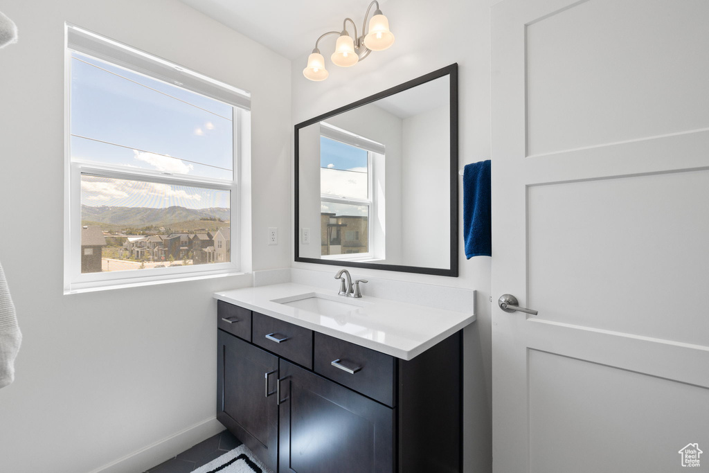 Bathroom featuring vanity and a chandelier