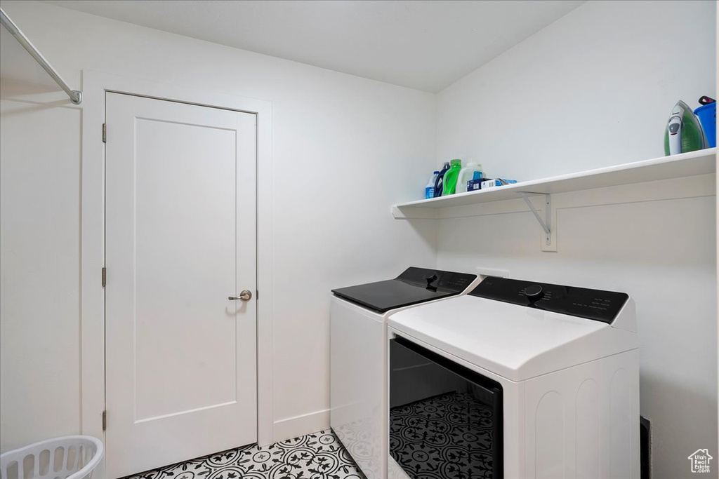 Washroom featuring washing machine and clothes dryer
