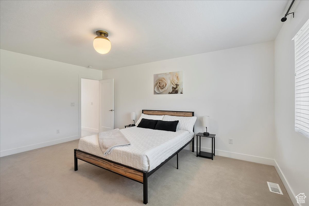 Bedroom with light carpet