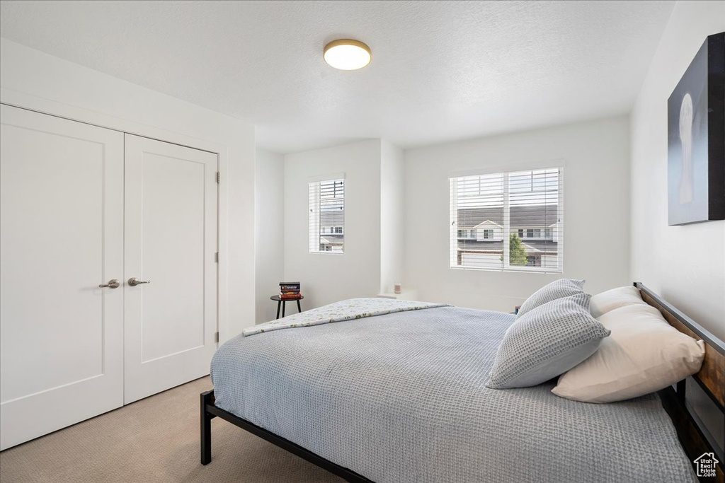 Bedroom with carpet and a closet