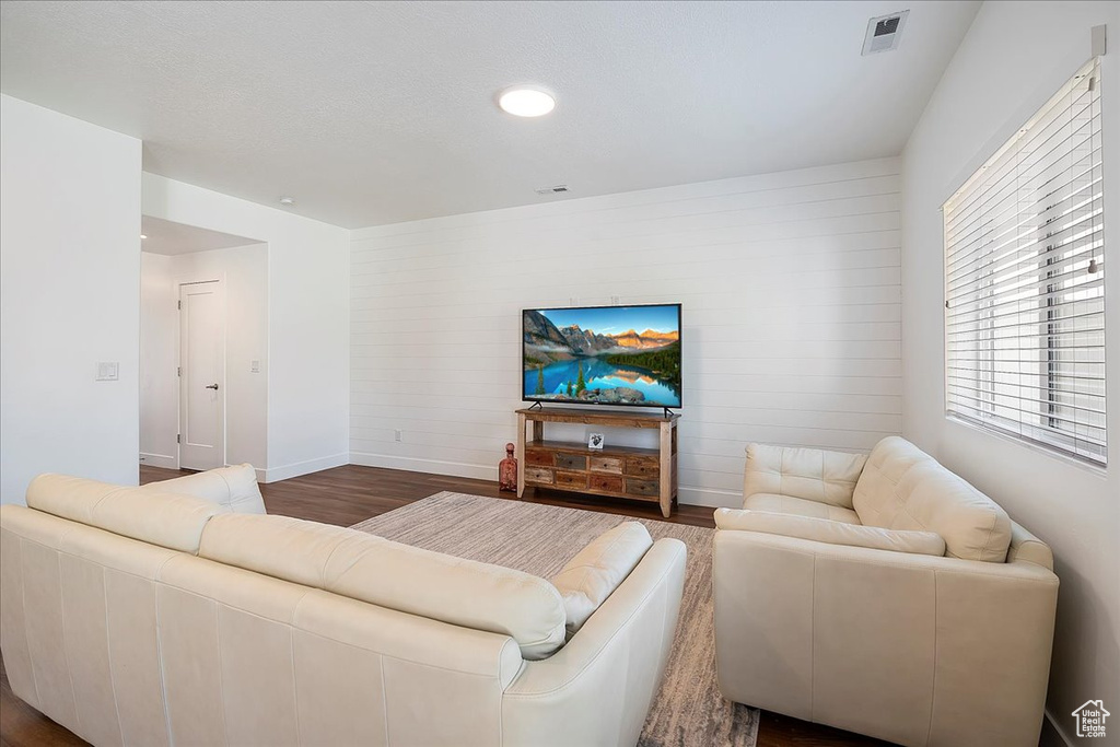 Living room featuring dark wood finished floors and recessed lighting