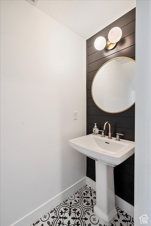 Bathroom with baseboards and tile patterned flooring