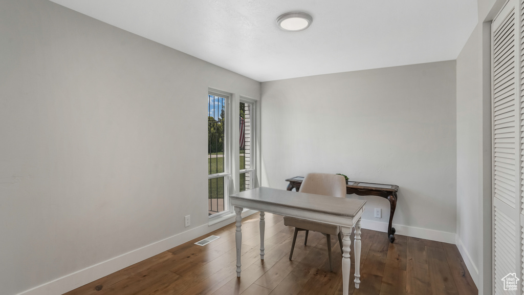 Office area with baseboards and hardwood / wood-style floors
