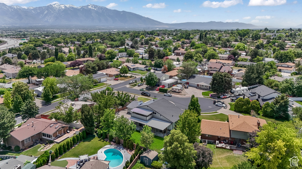 Aerial perspective of suburban area featuring mountains and a pool