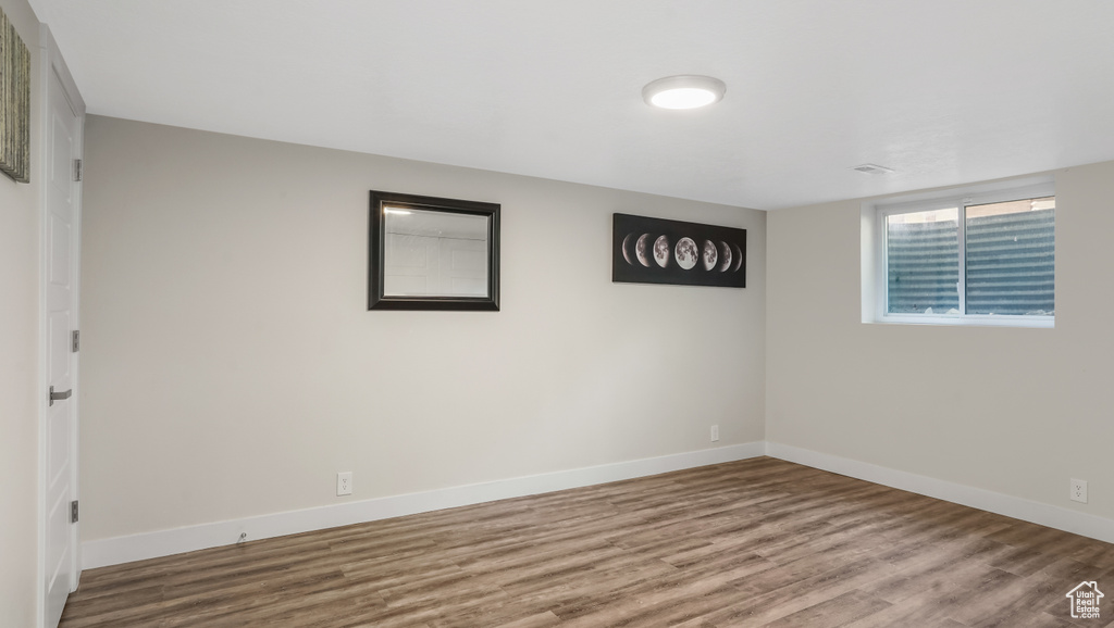 Spare room featuring wood finished floors and baseboards