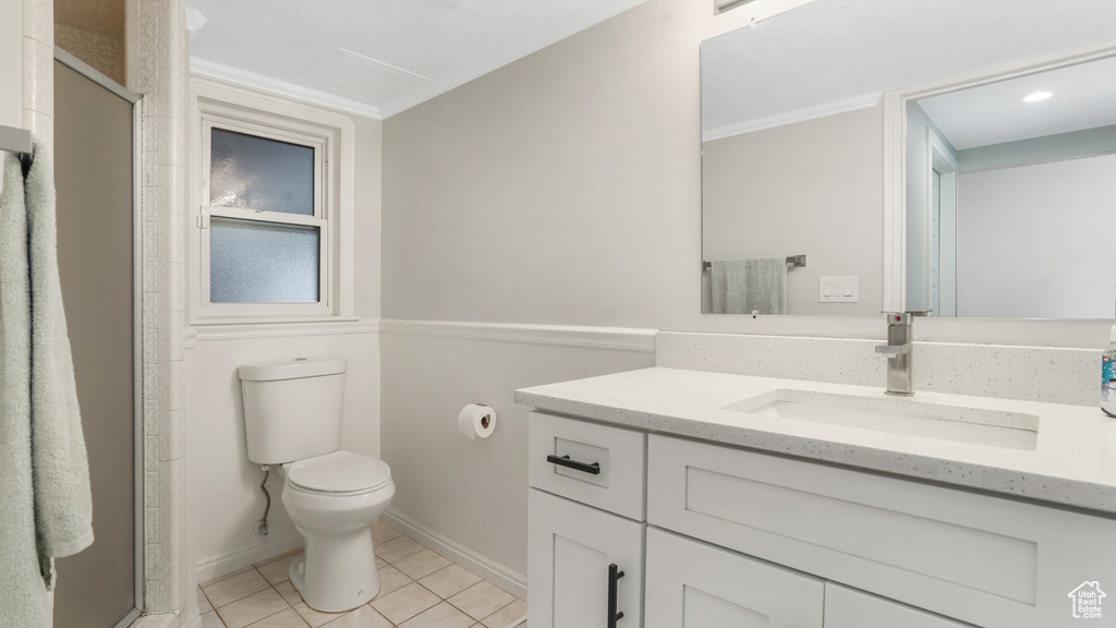Bathroom with vanity, tile patterned floors, a shower stall, ornamental molding, and recessed lighting