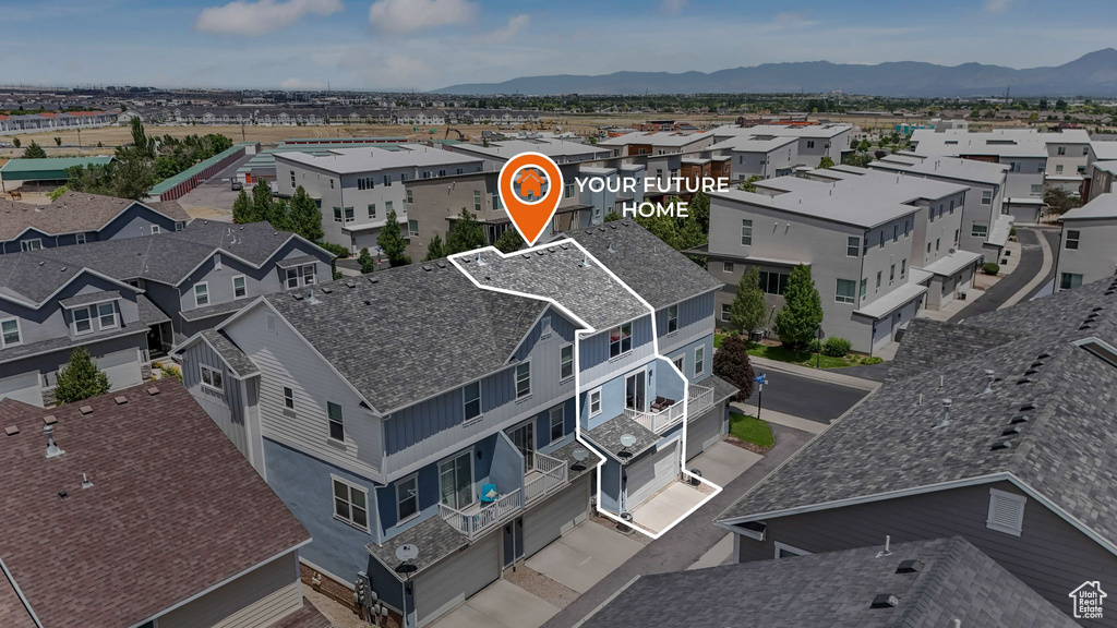 Aerial perspective of suburban area with a mountainous background