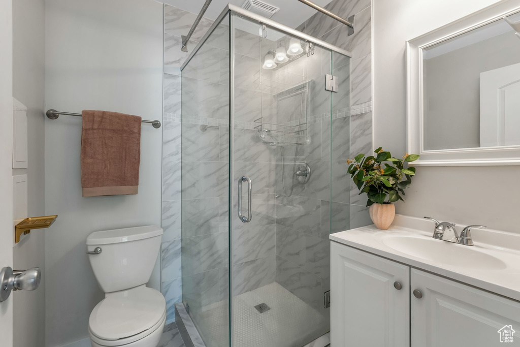 Full bathroom with vanity and a stall shower