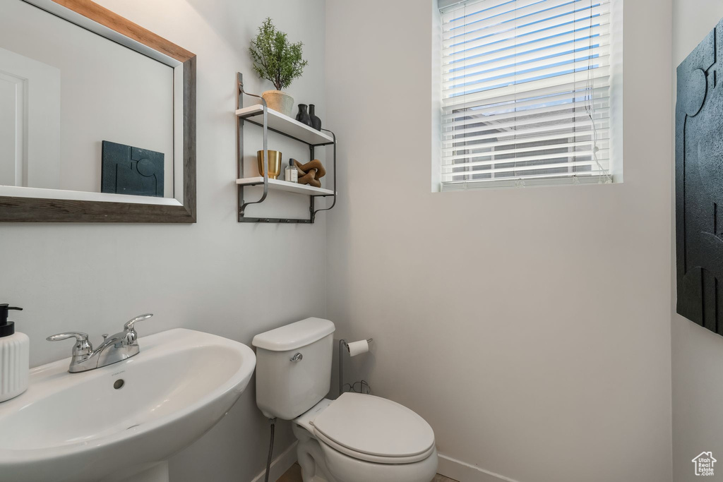 Half bath with a sink and toilet