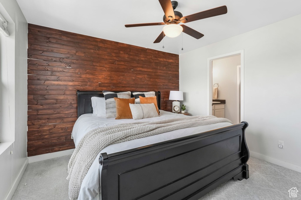 Bedroom featuring carpet floors, ceiling fan, and ensuite bath