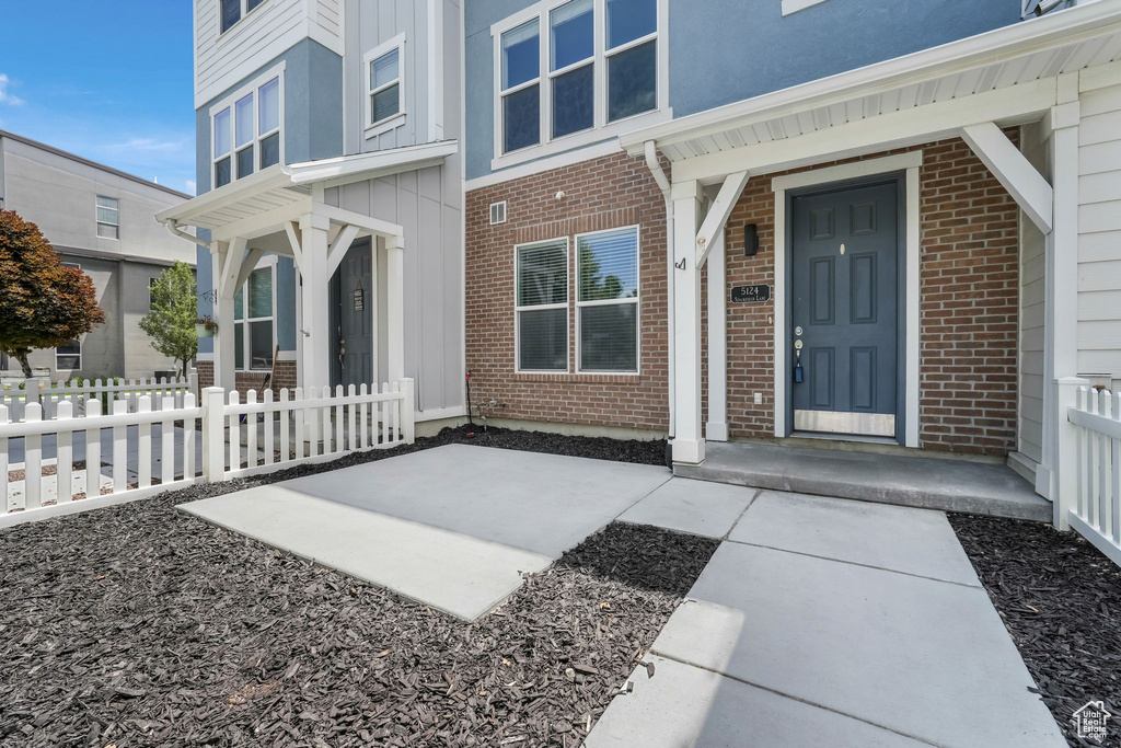 Entrance to property with brick siding and board and batten siding