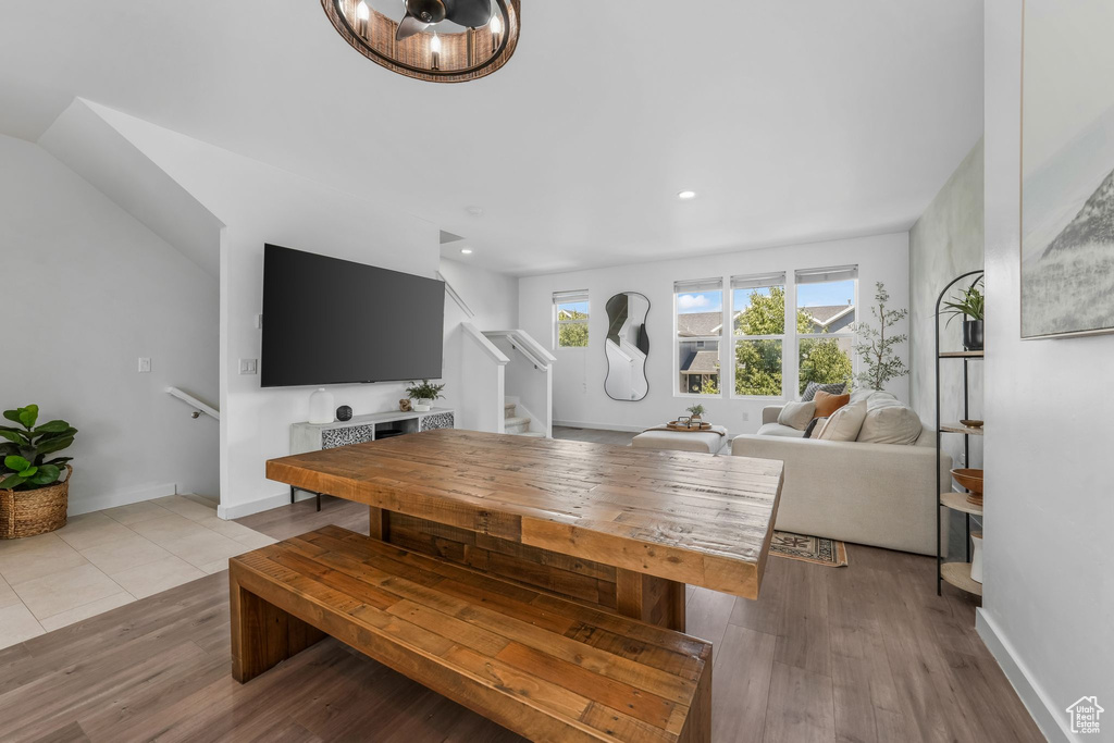 Dining space with stairs, recessed lighting, wood finished floors, and a chandelier