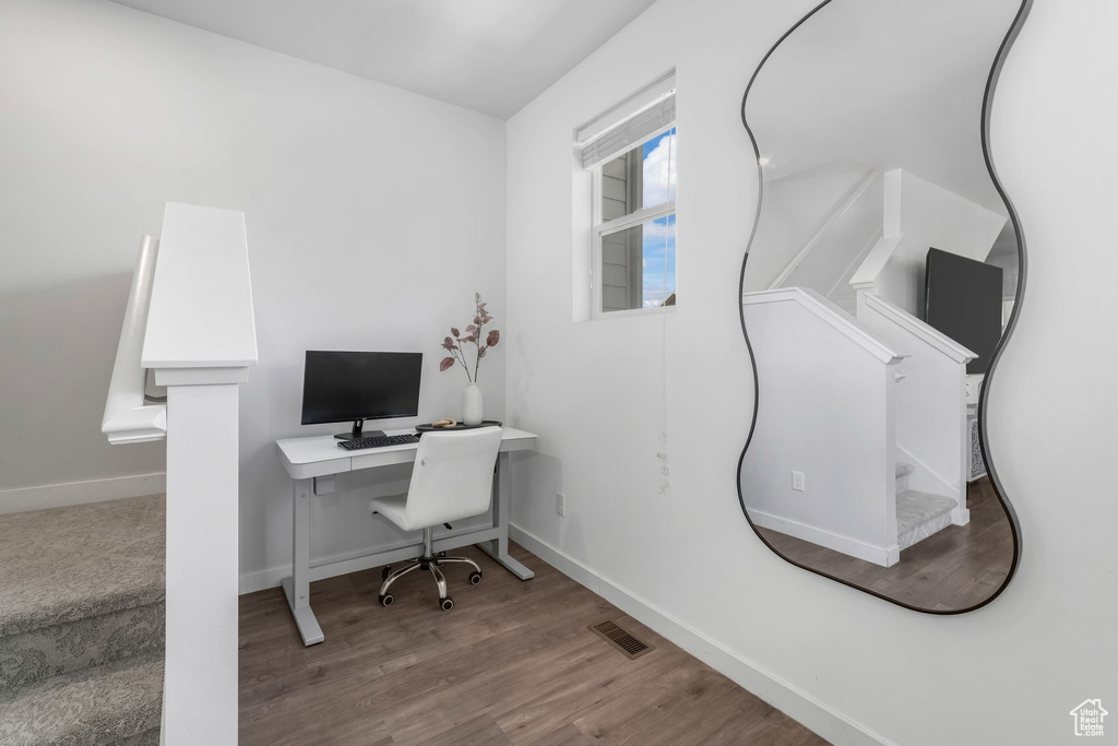Home office featuring wood finished floors and baseboards