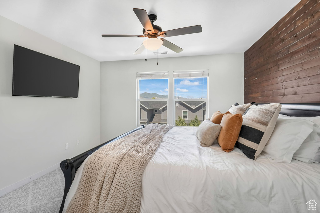 Bedroom with ceiling fan and carpet