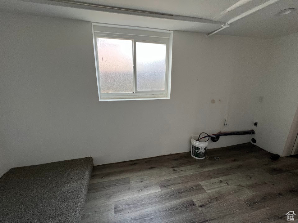 Washroom with electric dryer hookup and wood finished floors