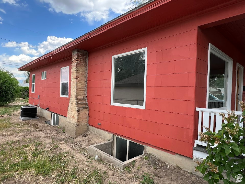 View of property exterior with a central AC unit