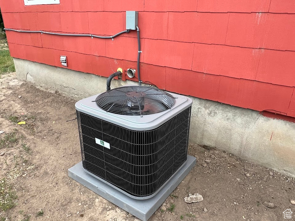 Exterior view of a central air condition unit and crawl space