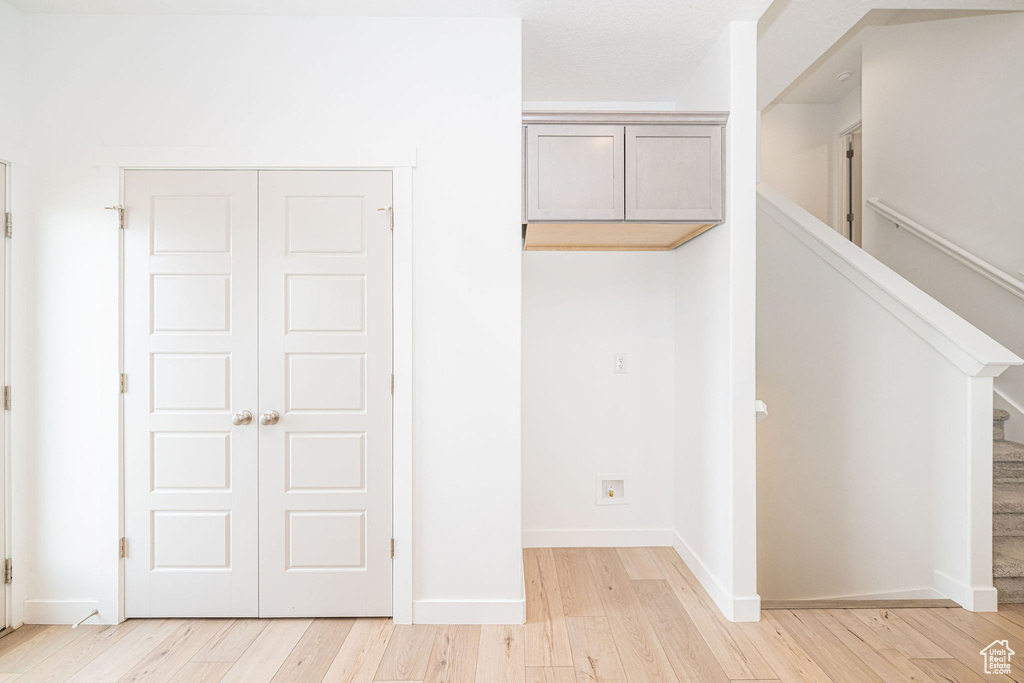 Unfurnished bedroom with a closet and light wood-style flooring