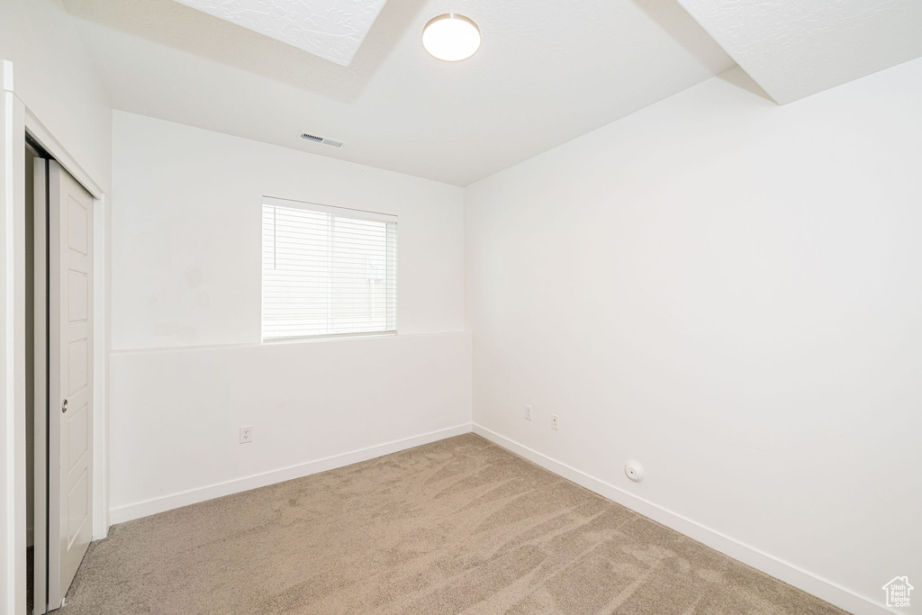 Unfurnished bedroom featuring carpet flooring and a closet