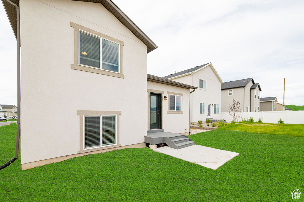 Rear view of property with stucco siding