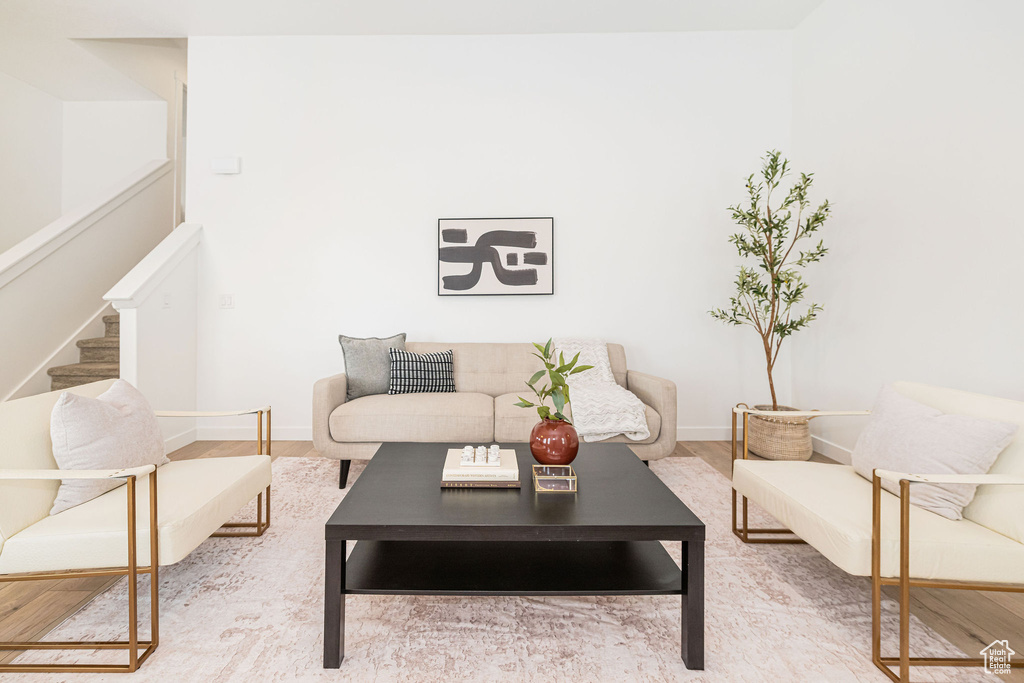 Living room with stairway and wood finished floors