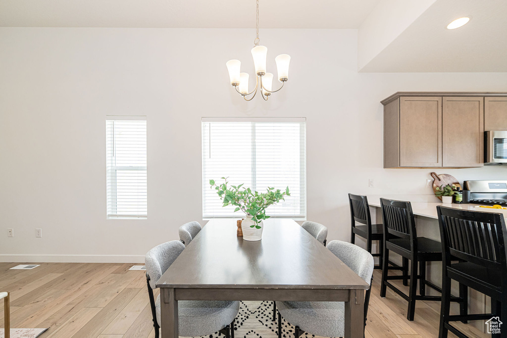 Dining room featuring a chandelier, light wood-style floors, and recessed lighting