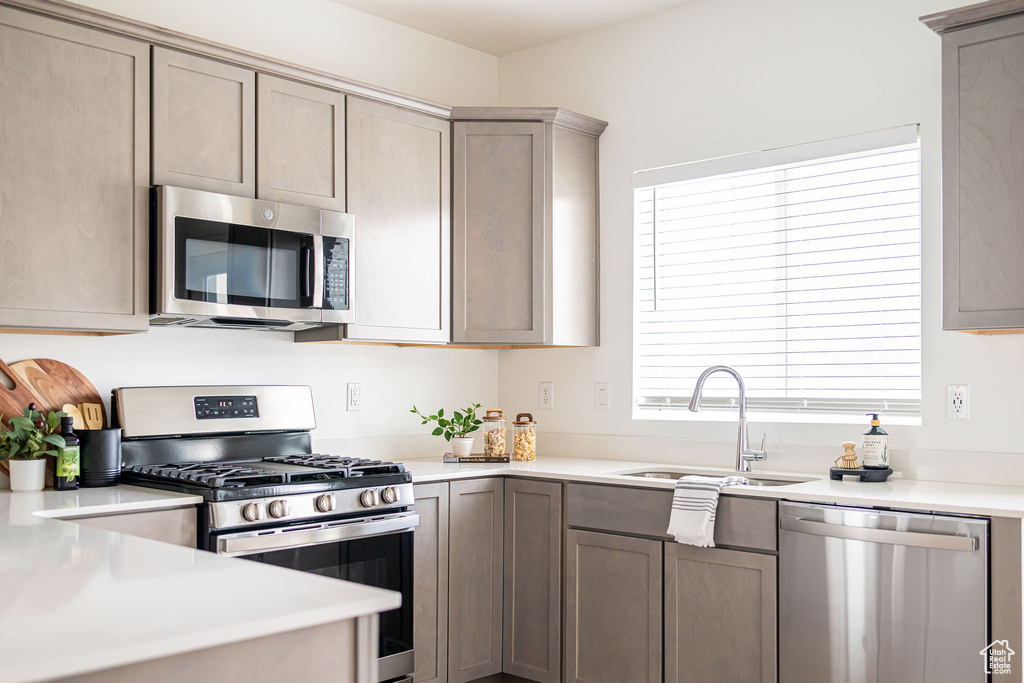 Kitchen with stainless steel appliances and light countertops