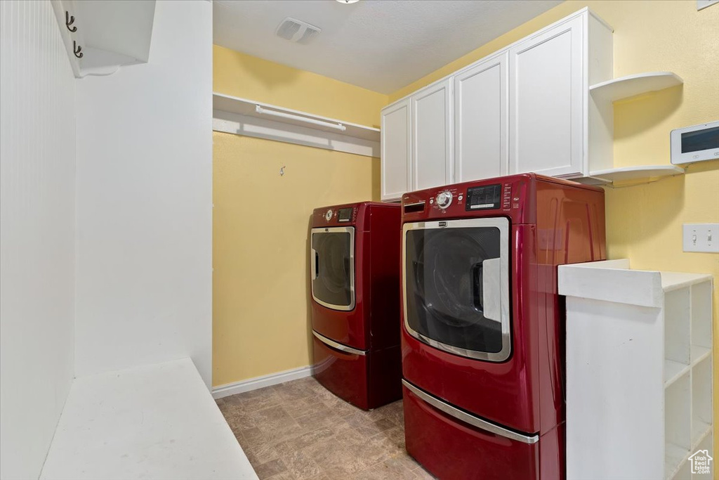 Washroom with washing machine and dryer and cabinet space