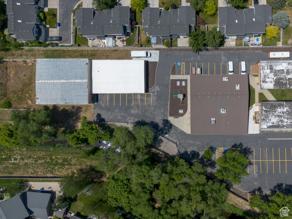 Aerial view of property and surrounding area featuring nearby suburban area