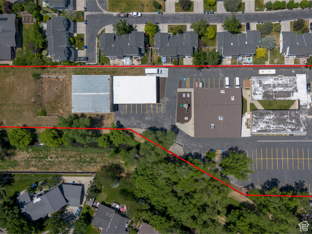 Aerial view of residential area featuring property boundaries highlighted
