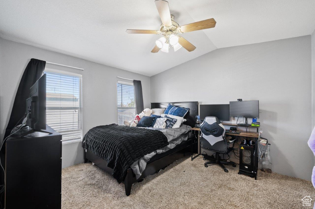 Bedroom featuring carpet, lofted ceiling, a ceiling fan, and an office area