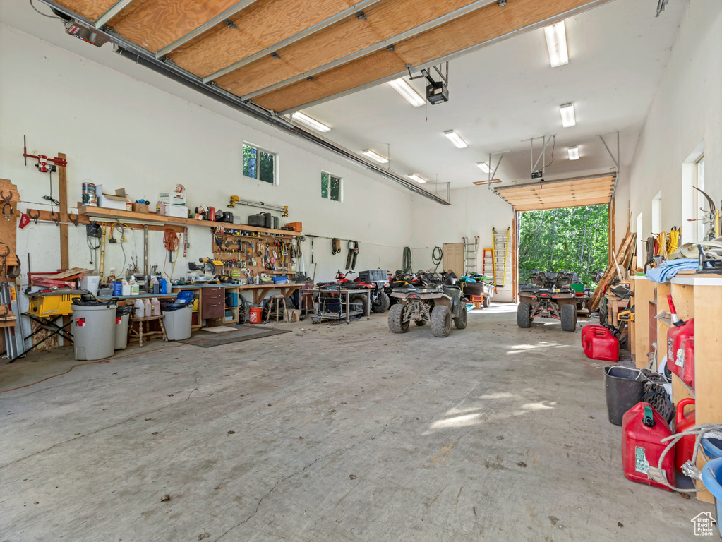 Garage featuring a workshop area and a garage door opener
