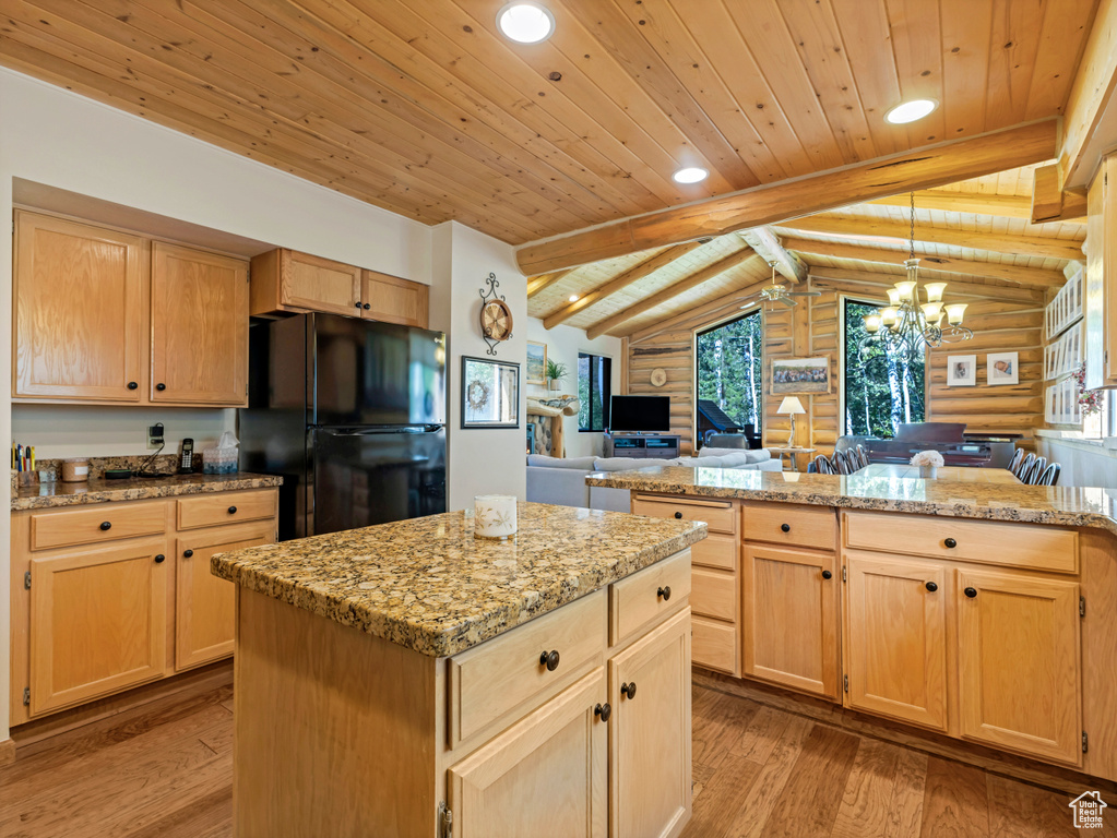 Kitchen with freestanding refrigerator, rustic walls, wood ceiling, light wood-style floors, and light brown cabinetry