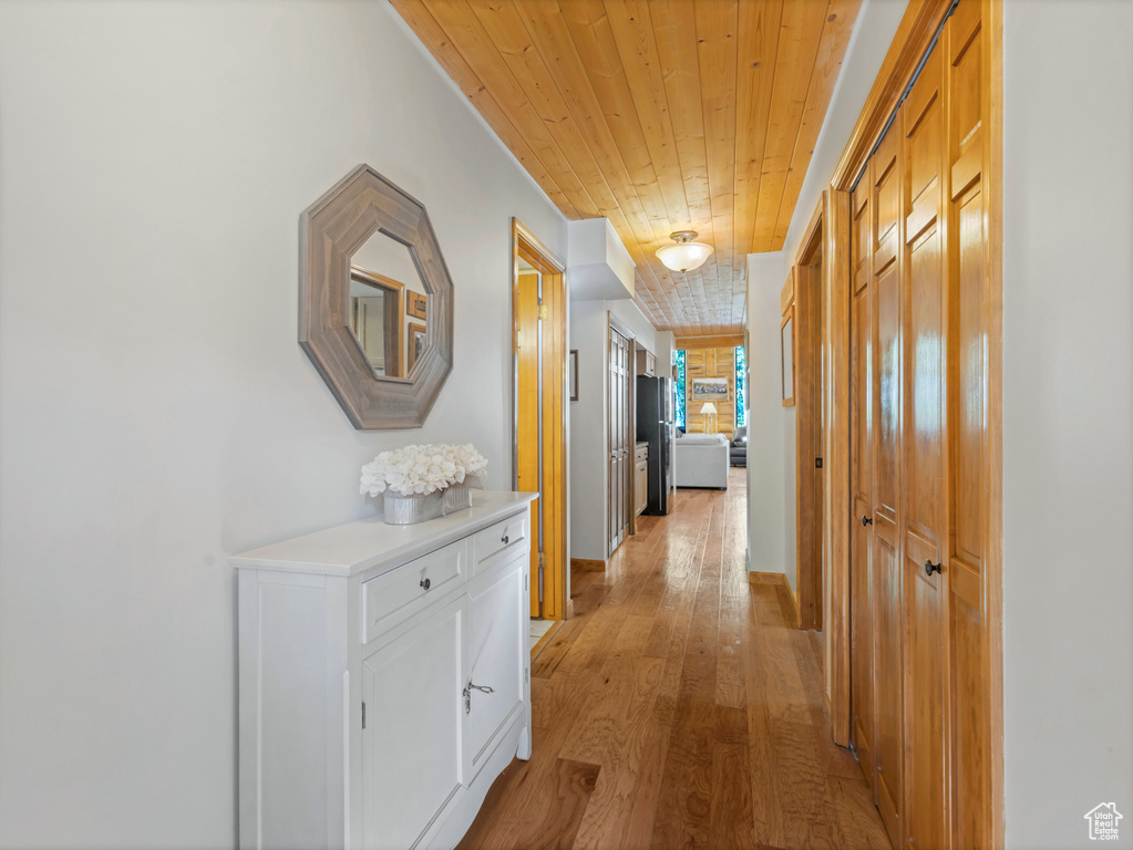 Hall with wooden ceiling and light wood-type flooring