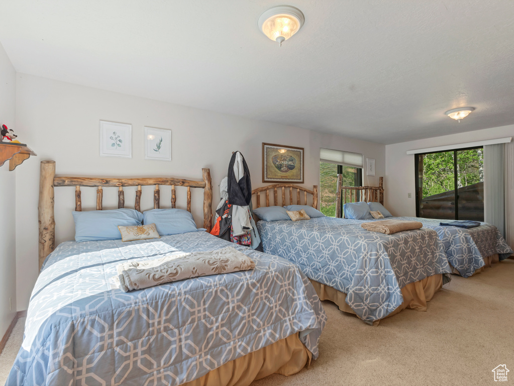 Carpeted bedroom featuring access to outside