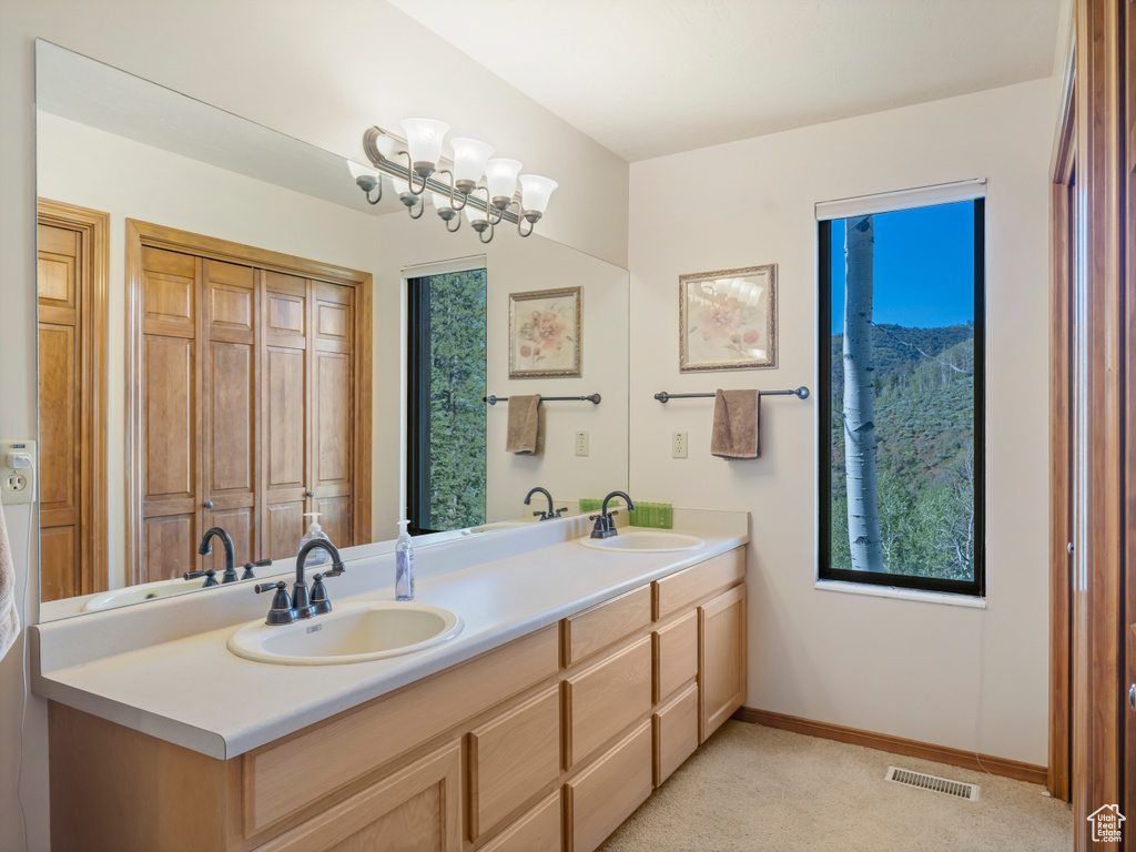 Full bath with double vanity and plenty of natural light