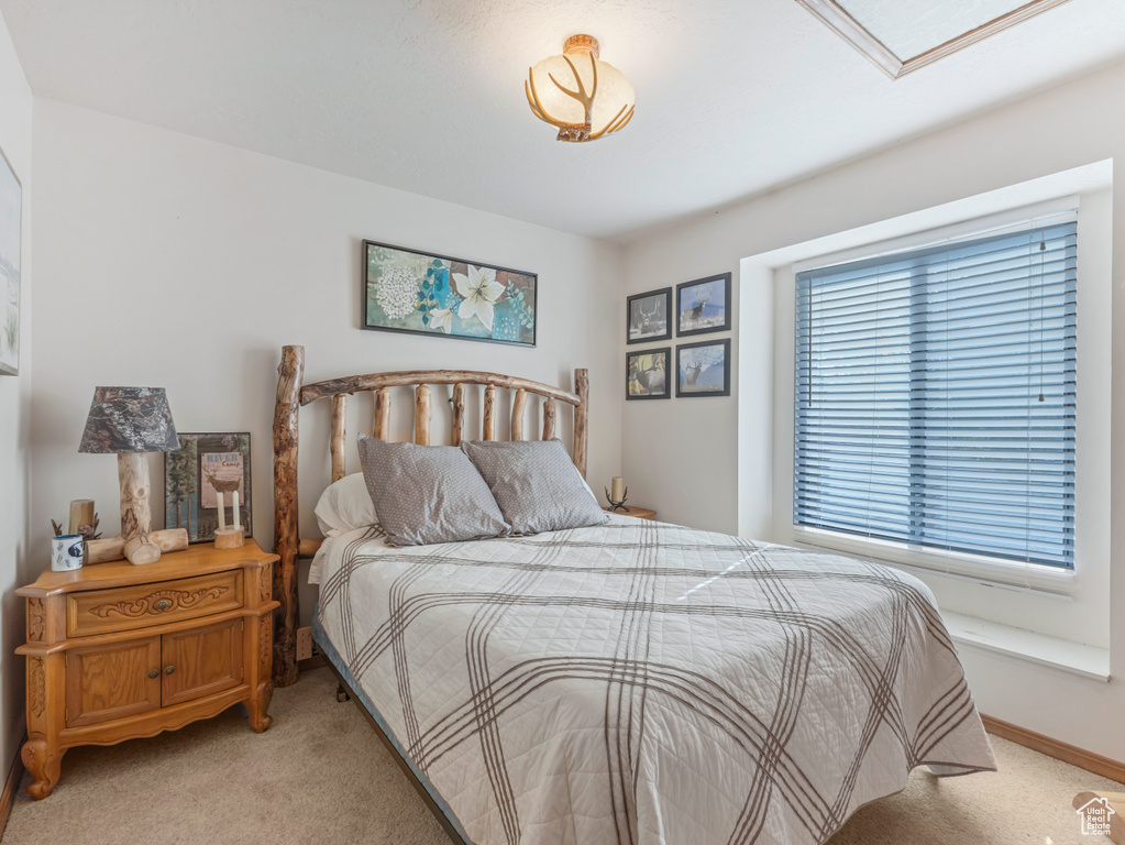Bedroom with light carpet and baseboards