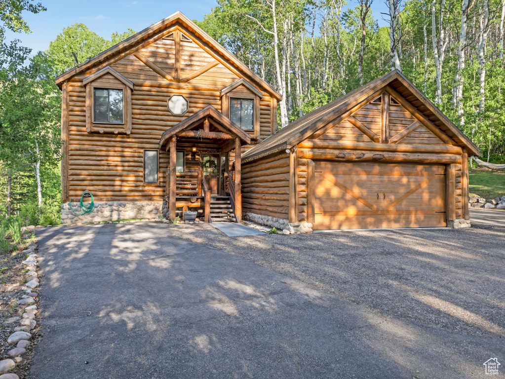 View of front of house with an outdoor structure and a garage