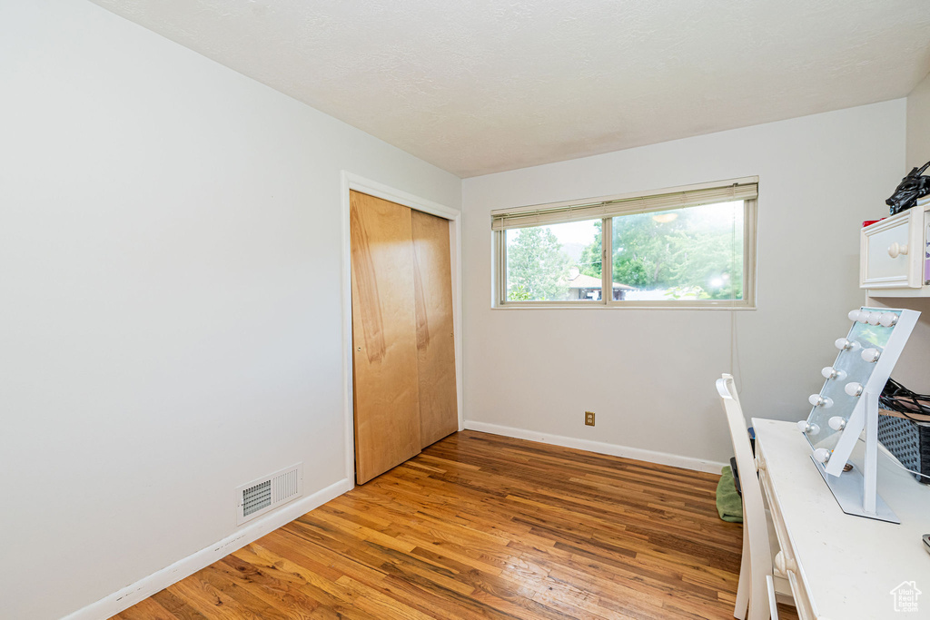 Unfurnished office featuring light wood-style flooring and baseboards