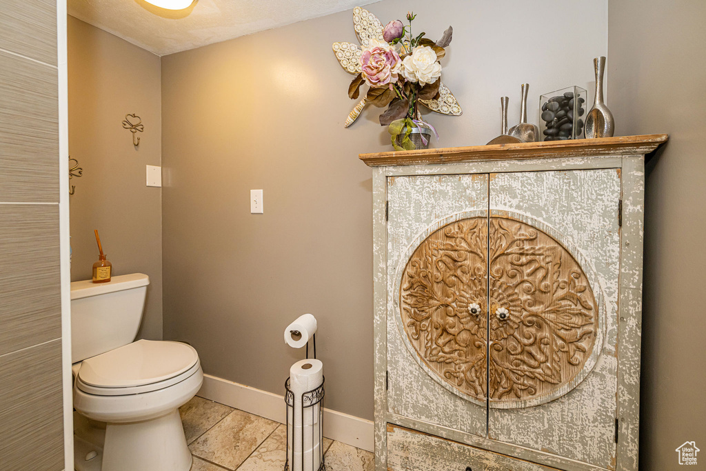 Bathroom featuring toilet and baseboards