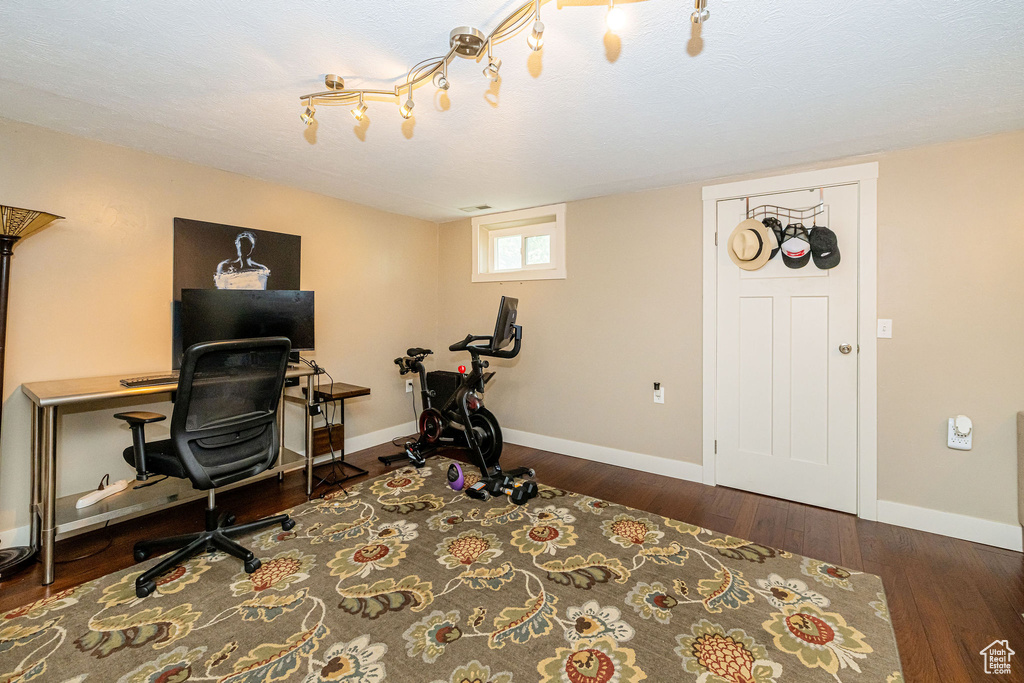 Office with wood finished floors and baseboards