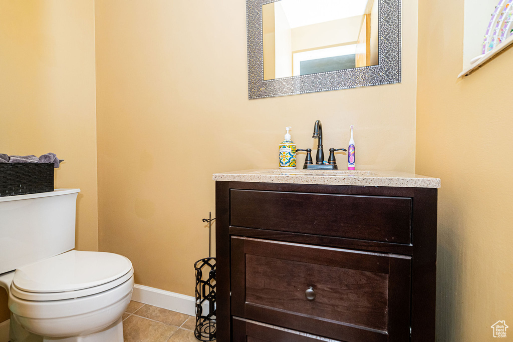 Half bath featuring vanity and tile patterned floors