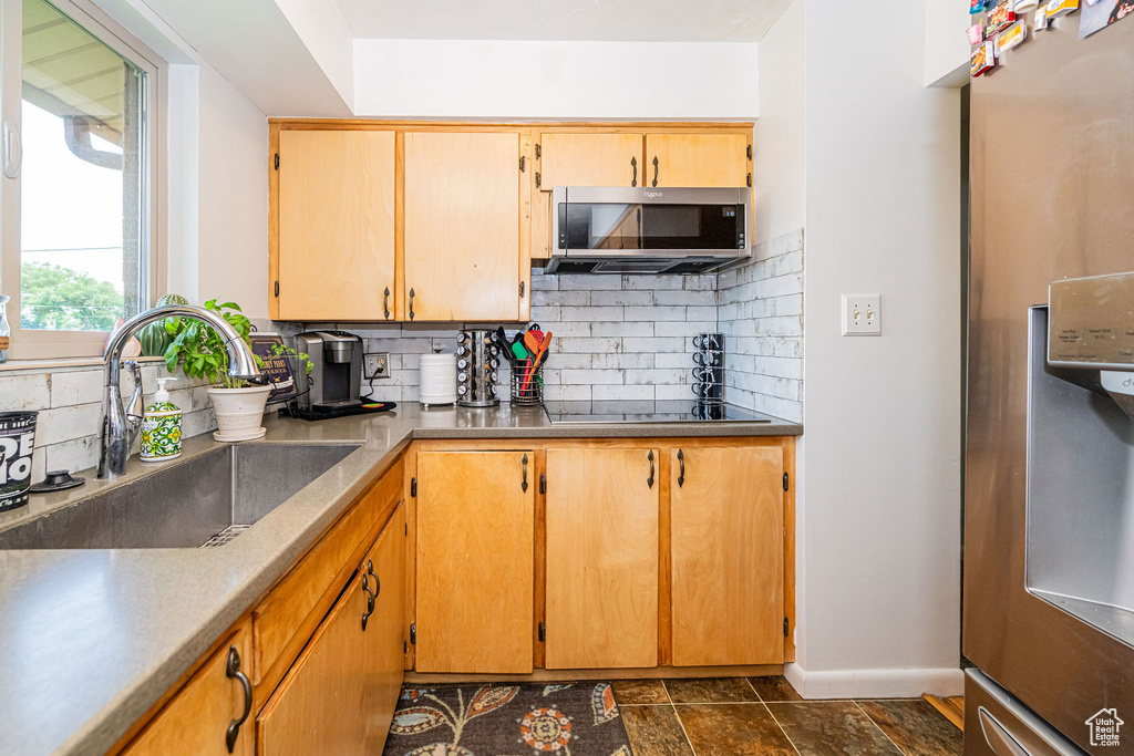 Kitchen with stainless steel appliances and backsplash