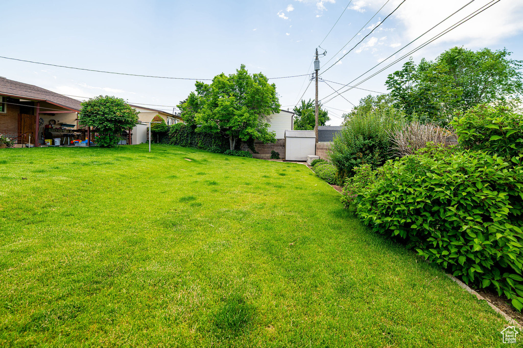 View of yard featuring a storage unit