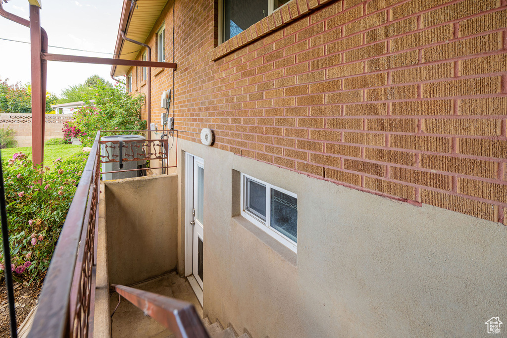 View of property exterior with brick siding